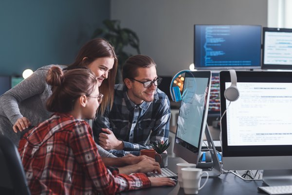 people sitting around a computer screen